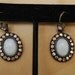 Avon NR signed opalescence lstone center surrounded with auroas borealis rhinestones .