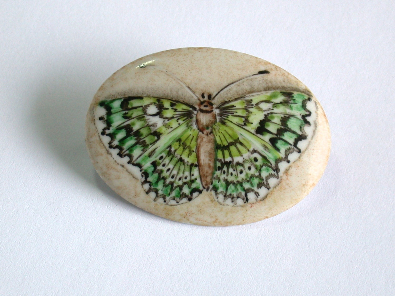 green butterfly handpainted porcelain brooch, on "parchment"color background - madrab green butterfly handpainted porcelain brooch, on "parchment"color background - madrab