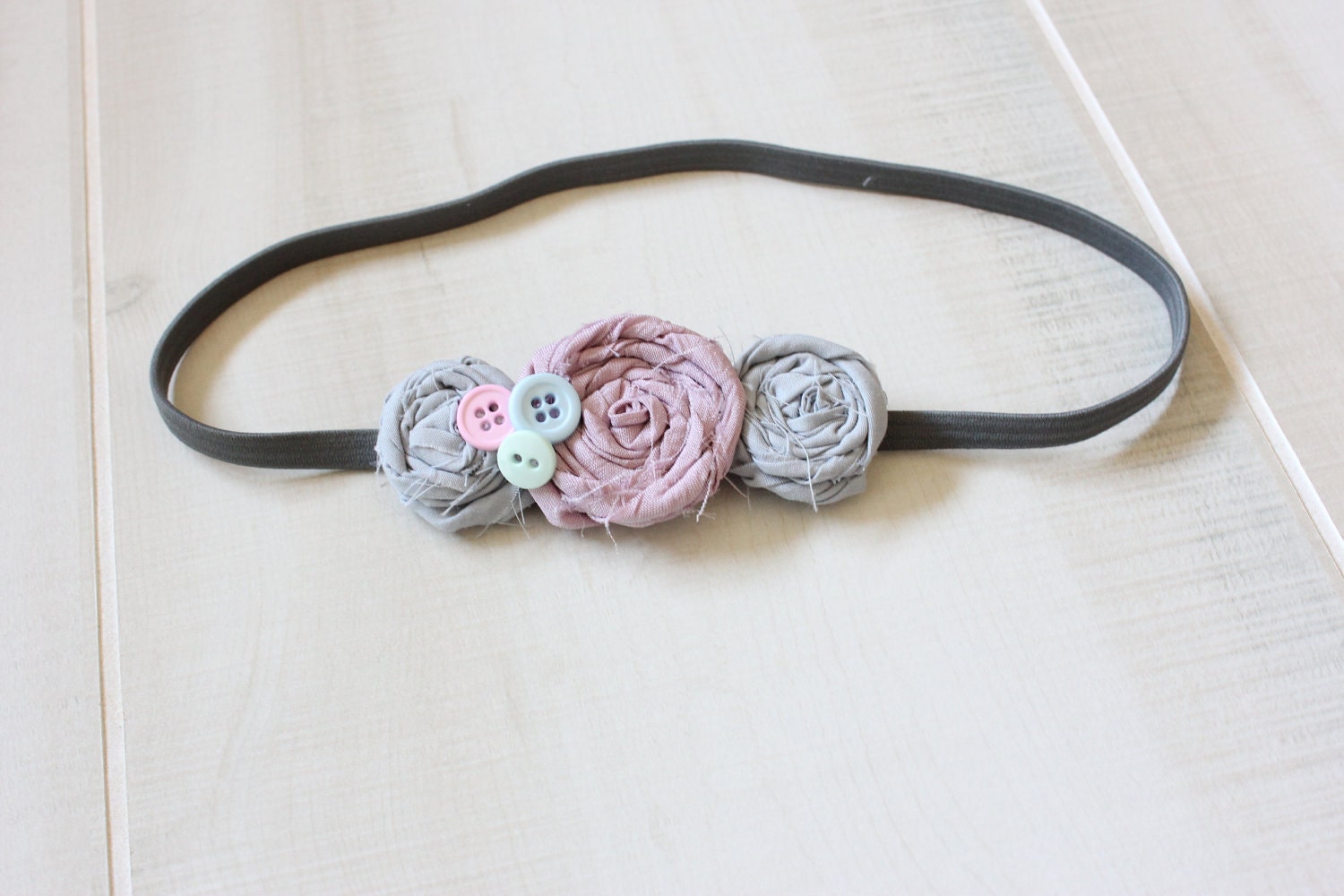 Grey Elastic Headband featuring purple and light grey rosettes