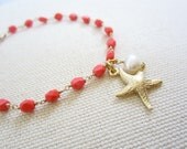 Hand wired Coral Firepolish Bracelet with 18k Gold plated starfish charm and fresh water pearl.