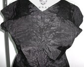 1950's wiggle black faille dress with fan pleated bodice and bow. Little black dress with great tailoring.