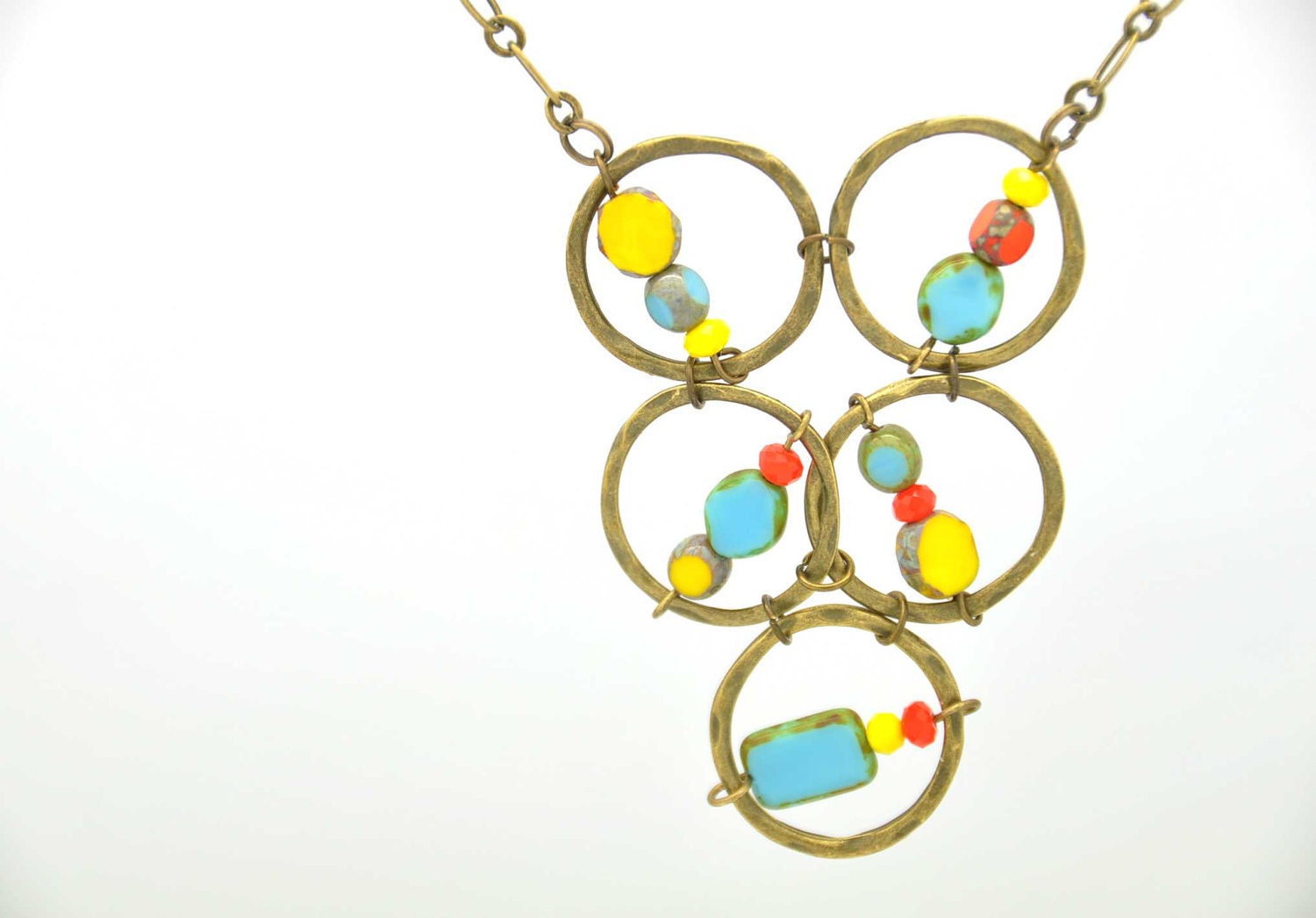 Fun necklace made with Turquoise blue and yellow Czech Picasso glass beads, yellow and orange crystals and antique brass hammered circles