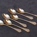 Six Goldtone Demitasse Spoons with decorations on both sides ABL-093