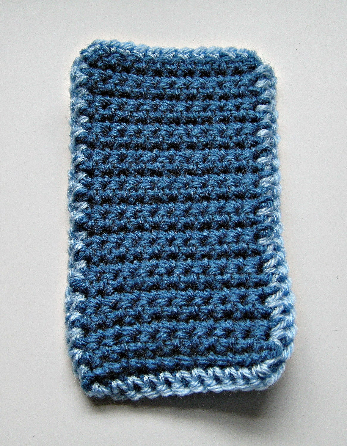 Crocheted iPod cover in dark blue with a pale blue trim