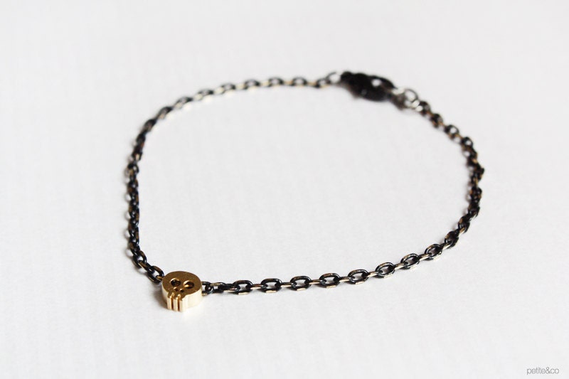 tiny skull bracelet - matt 14kt gold plated skull on BLACK chain