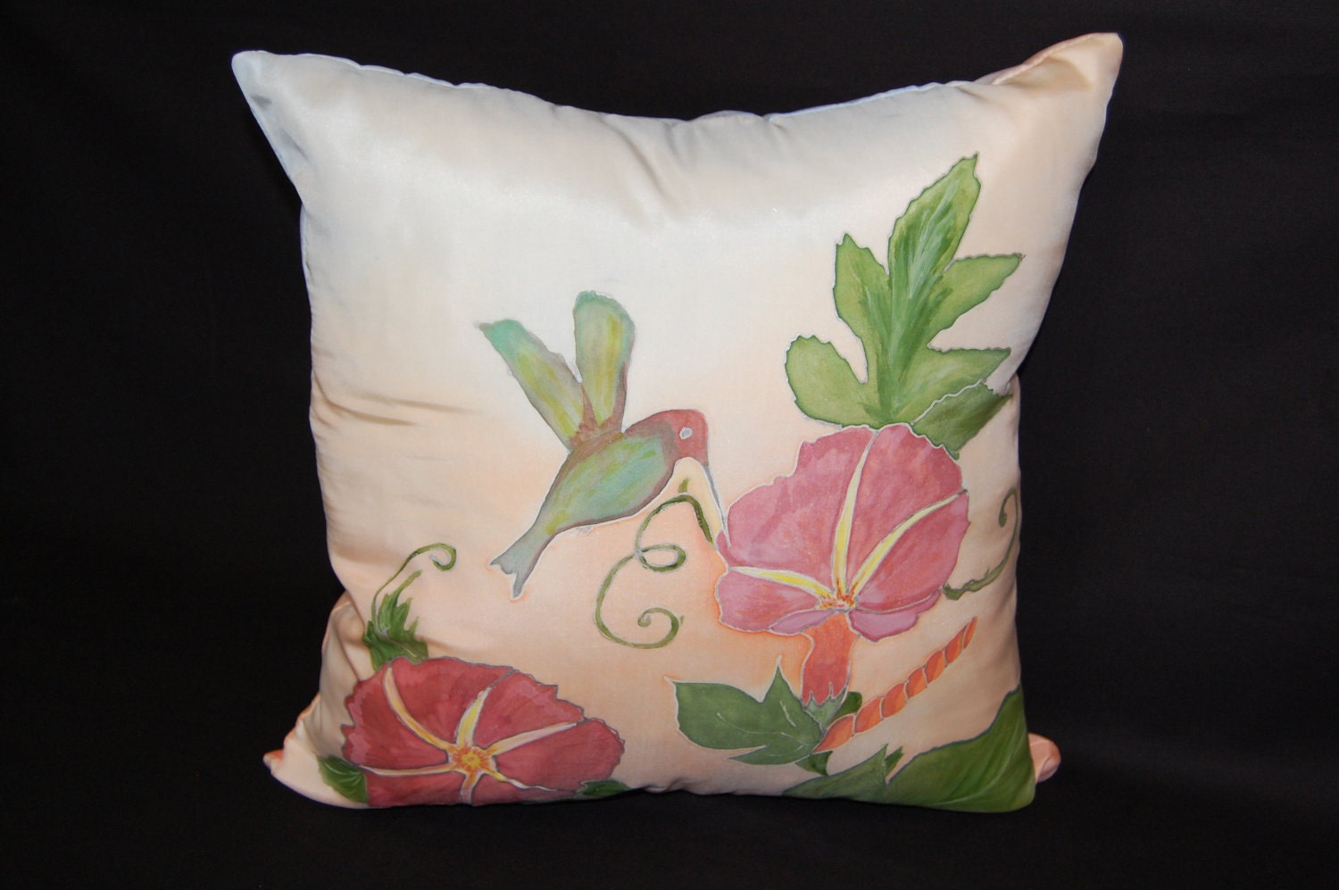 Hand painted Silk pillow . A red Morning Glory Flowers with green leaves,  humming birds with peach and little blue on a background.