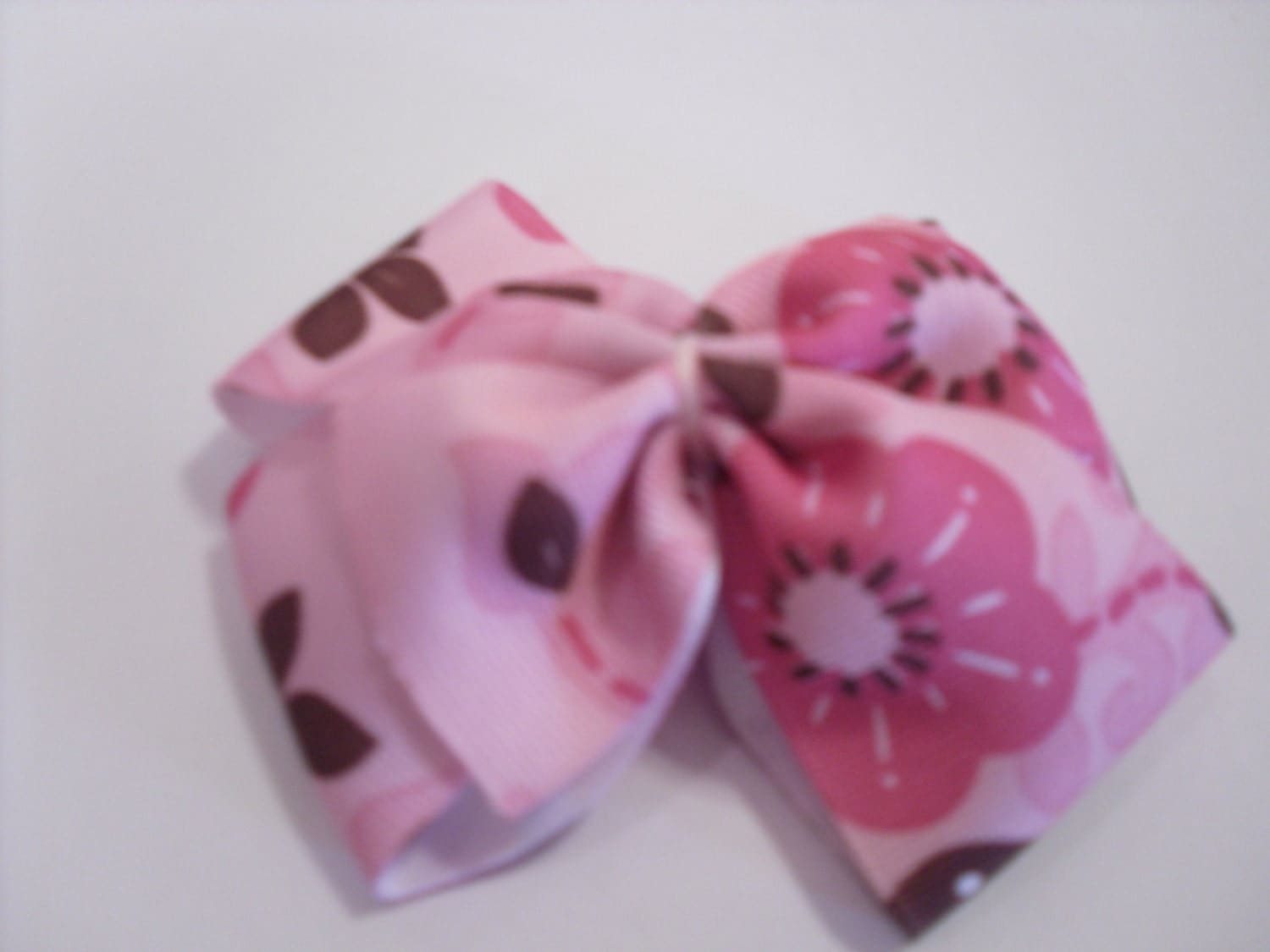 Pink bow with dark pink and brown flowers