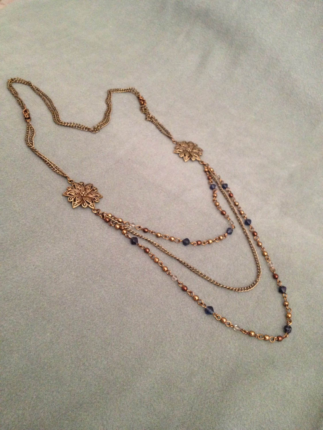 Reserved long necklace in vintage bronze with bronze , bleu and grey beads