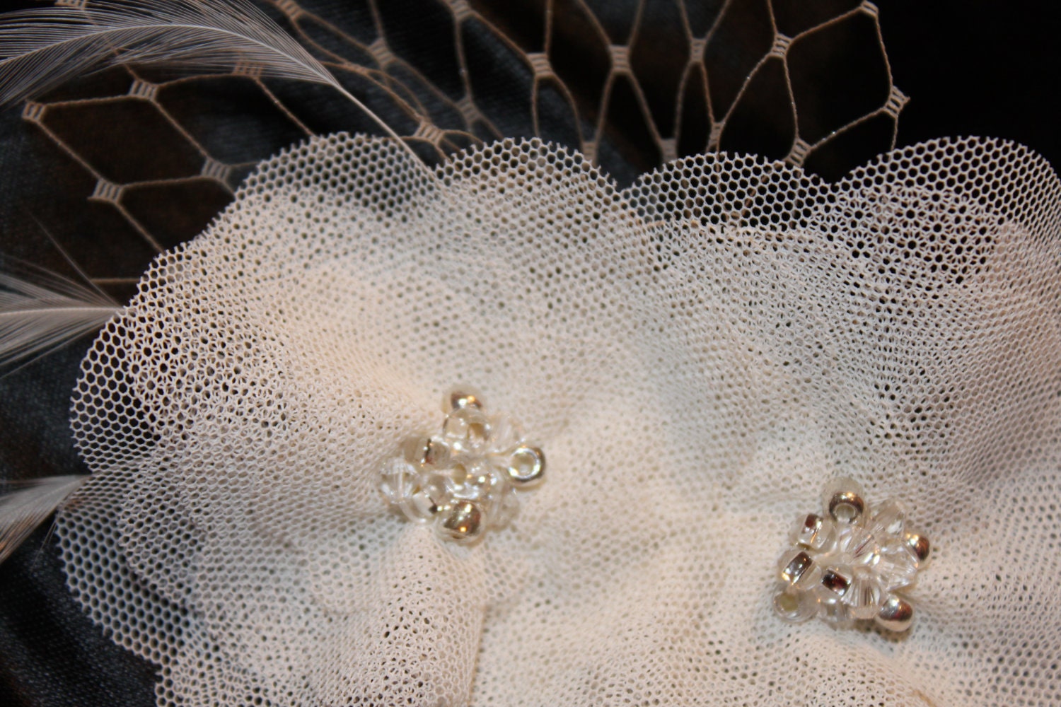 fascinator in ivory with layers of tulle, feathers, french birdcage veiling and crystal center for the bride