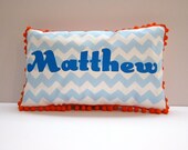 Baby pillow in baby blue chevron with bright blue lettering. Personalized with name.