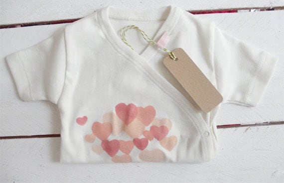 Organic bodie handprinted with heart motif in apricot