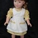 18 in Doll Dress and Pinafore, Betty Outfit in Yellow with Muslin Pinafore.
