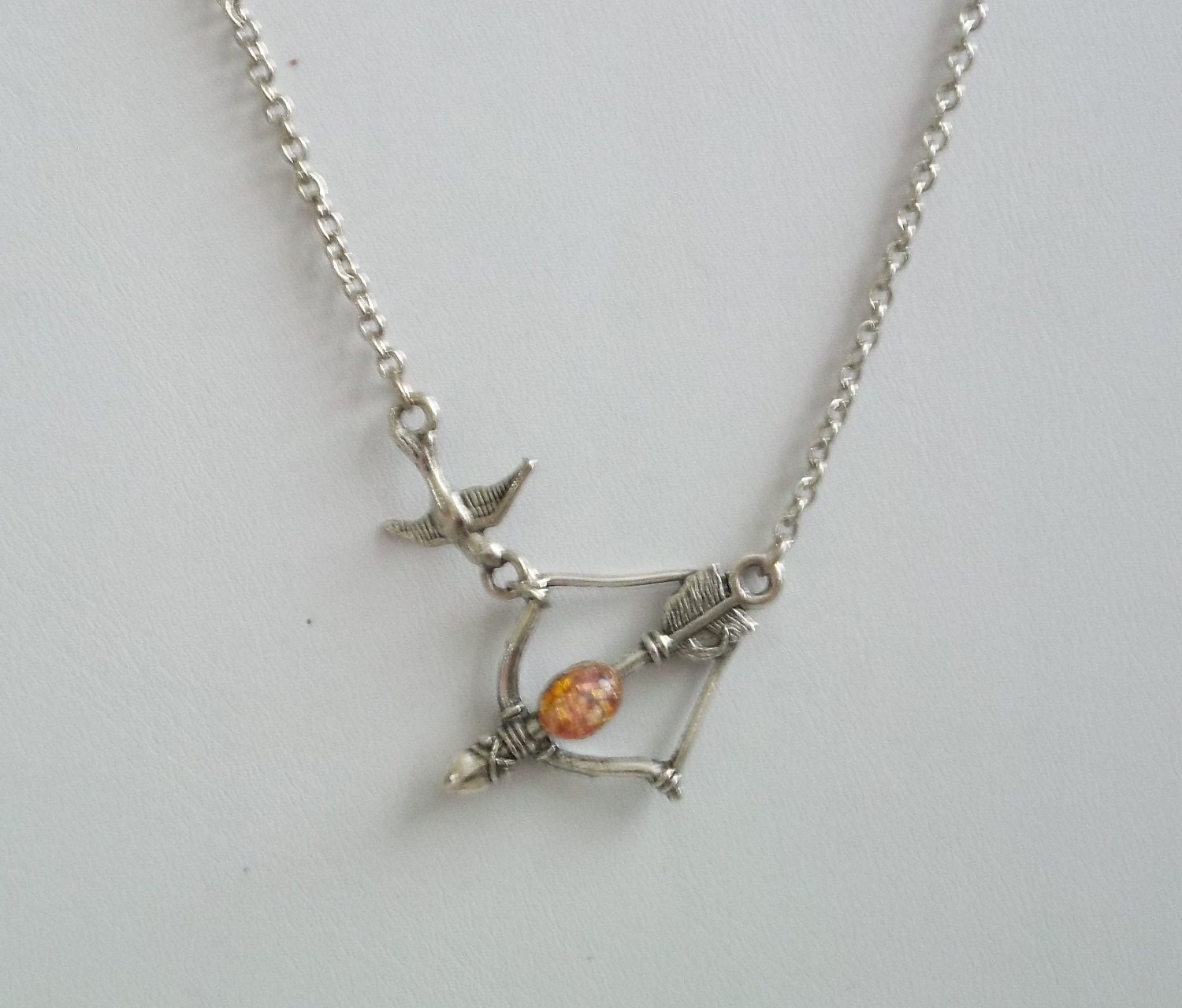 Asymmetrical Hunger Games Girl on Fire Katniss Bow and Arrow Mockingjay Necklace with Glass Fire OPal Cabochon