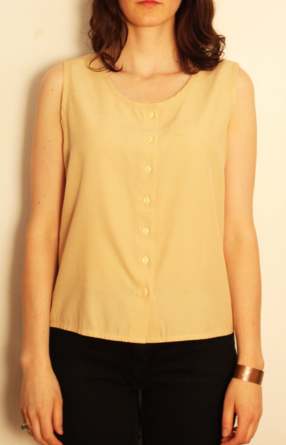 beige button down sleeveless blouse