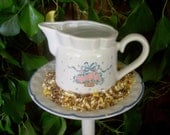 Creamer birdfeeder poke creates a charming addition to your flower garden