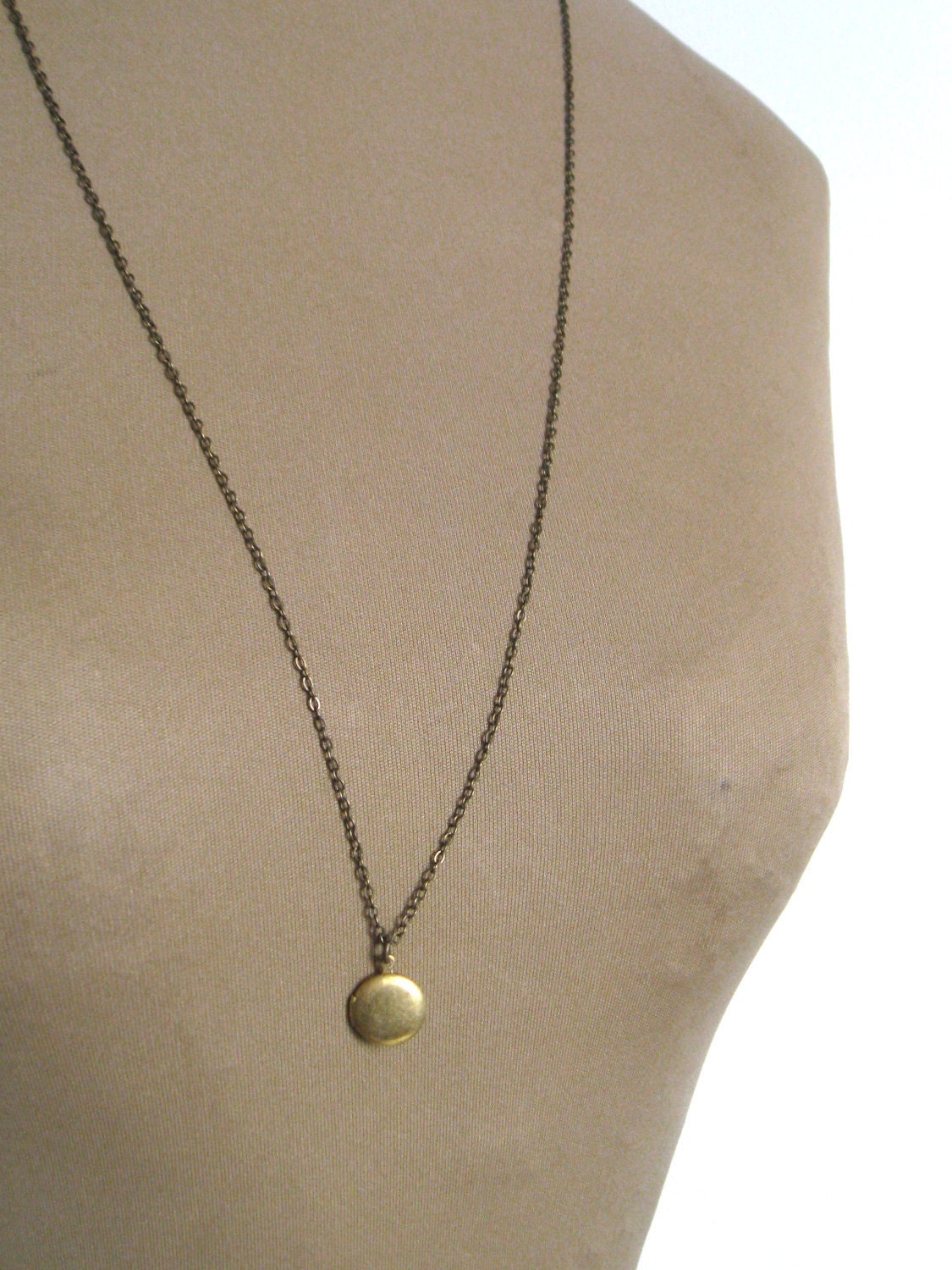 super long little locket necklace.