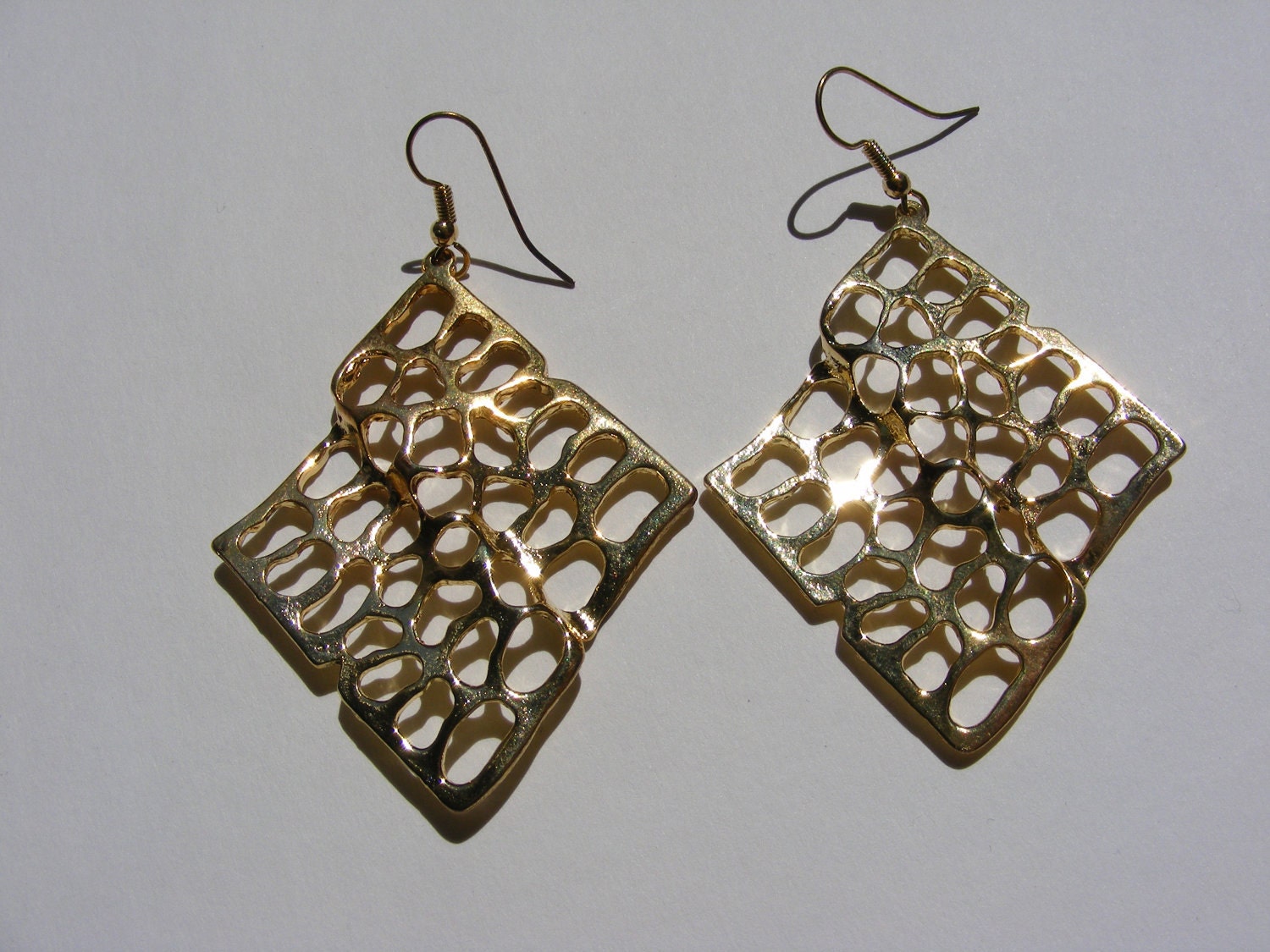 Gold Abstract earrings 1980's. Perforated metal, large, long, dangling. Modernist Gypsy. Unworn Vintage.