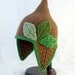 Pointed Brown Baby Hat with Earflaps and Varying Green Leaves