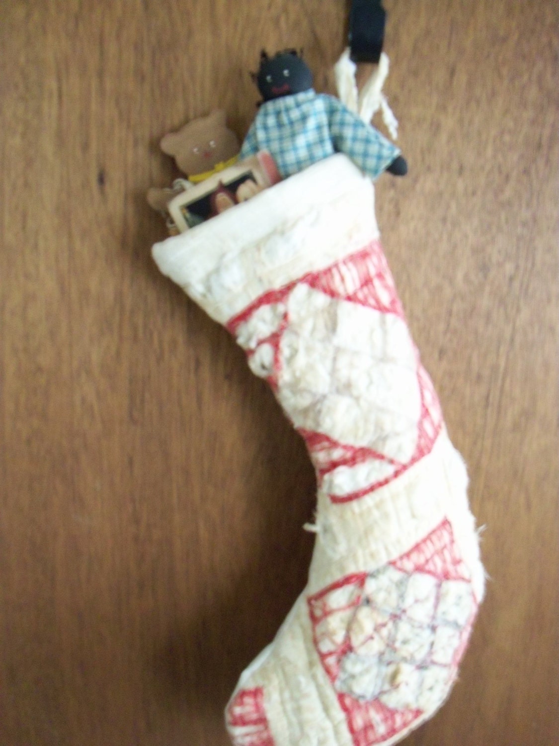Primitive tattered and torn stocking door warmer