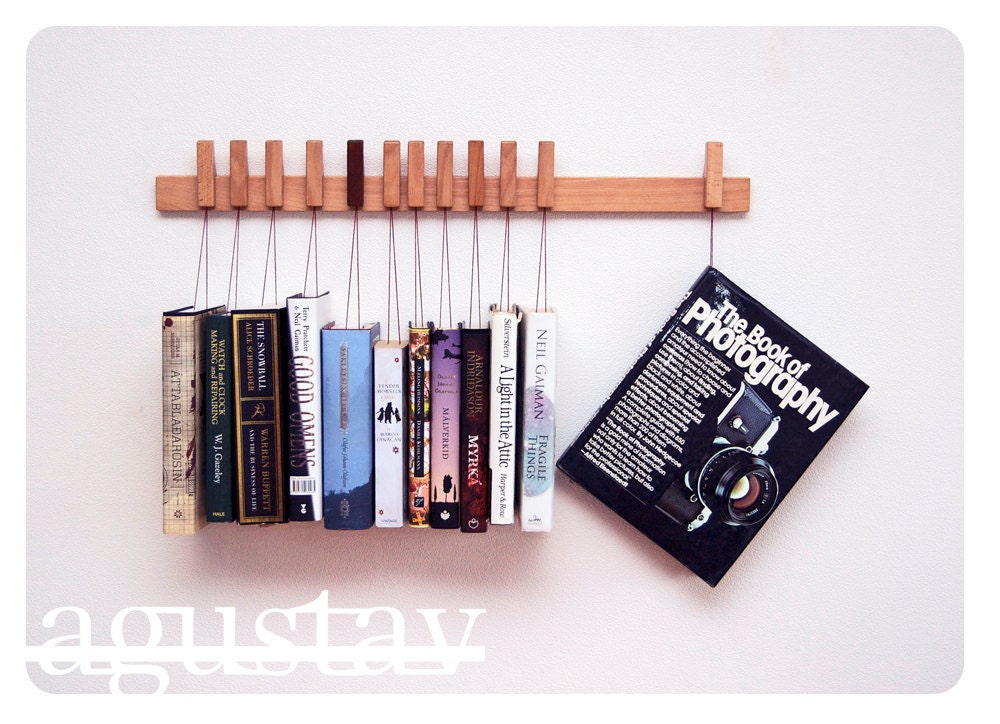 Custom made wooden book/magazine rack in Beech.The pins also work as bookmarks.