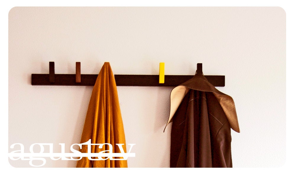 Custom made wooden coat rack in Wenge. Movable pins. Can be customized to fit every room of the house.