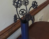 Bouquet of Spigot Flowers in a Purple Welded Vase