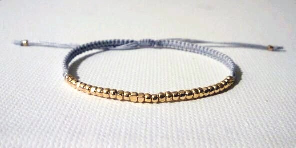 shyly. dainty colorful woven friendship bracelet tiny faceted gold bead nuggets