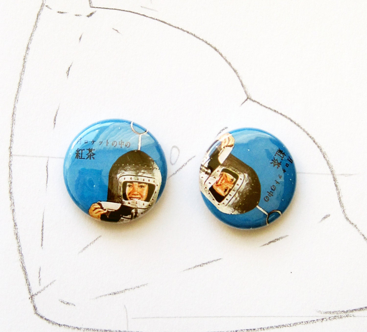 a pair of vintage japanese tea advertisement pin buttons
