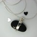 Black Pebble Adorned in Sterling Silver and a Heart. LAKE STONE
