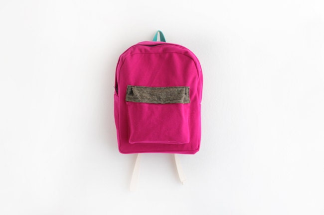 Magenta wool backpack with brown tweed pouch.