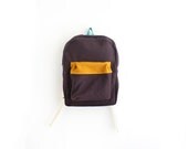 Dark brown wool backpack with mustard pouch.