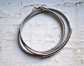 light grey skinny leather triple wrap bracelet with long silver tube