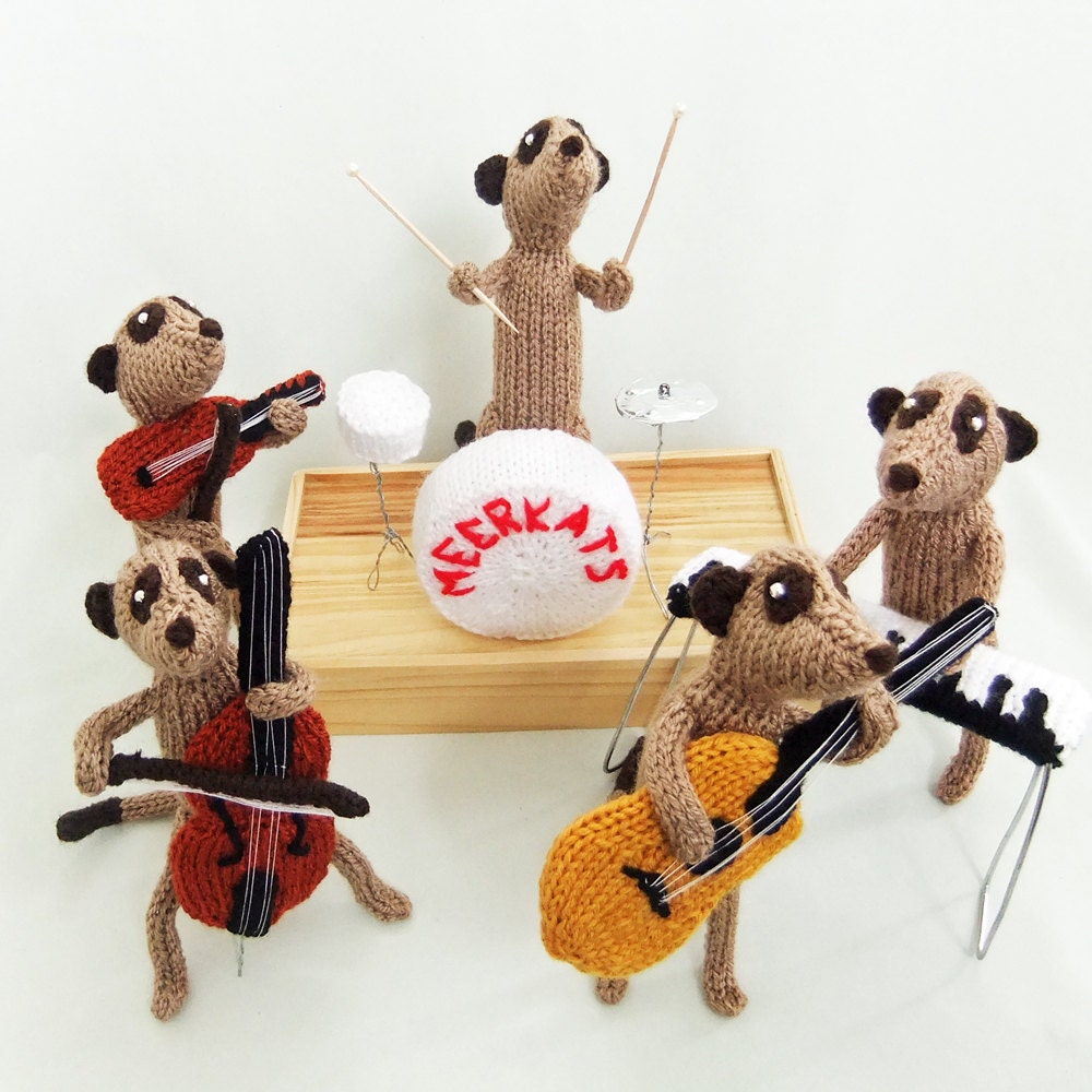 Meerkat pianist, piano player, playing a knitted piano, keyboard, musician, musical, music, meercat