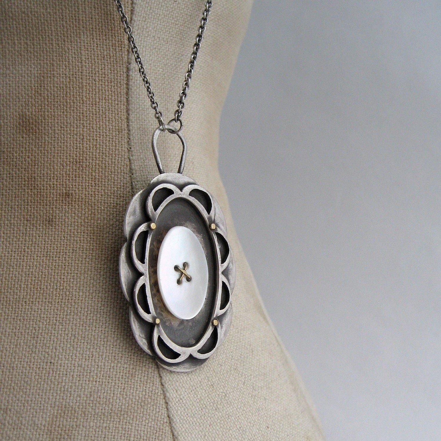 PENDANT sterling filigree oval, old button, and 18k gold rivets