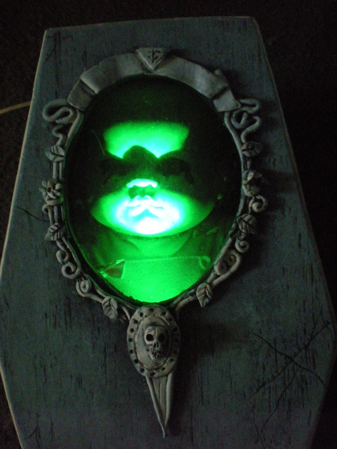 The Orphanage Coffin display case with creepy green lights.