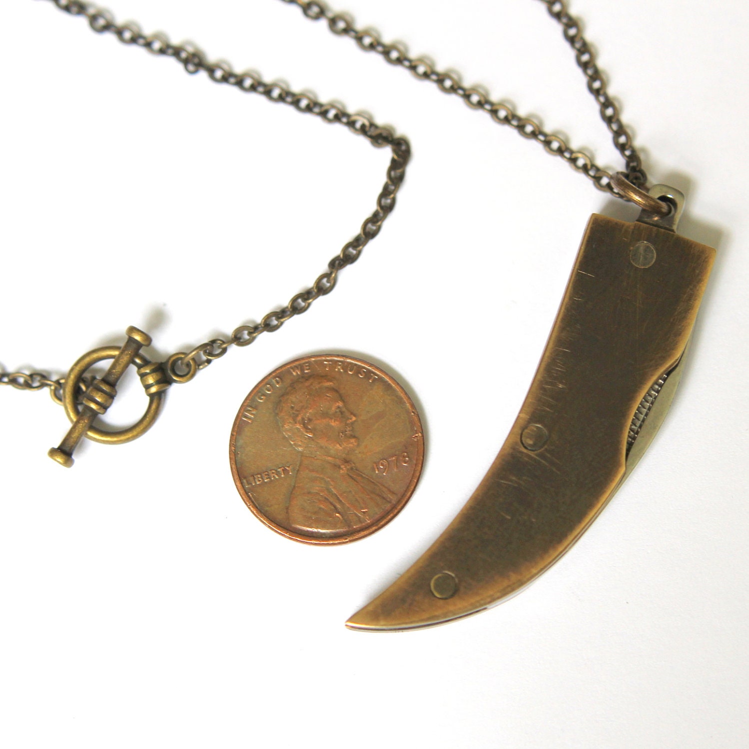 Genuine Amber Bone Claw Pendant Necklace with a Hidden Folding Knife Blade