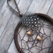 dark brown dream catcher with mixed feathers