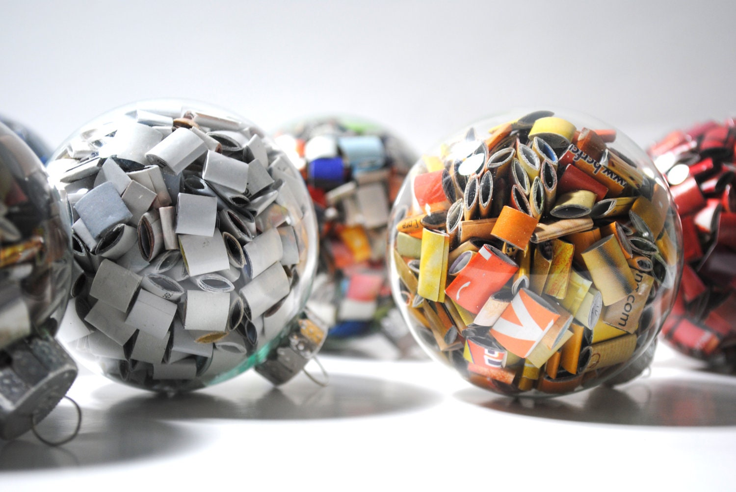 large colorful glass ornaments- made from recycled magazines, red, blue, green, yellow, orange, multi-colored, white, neutral