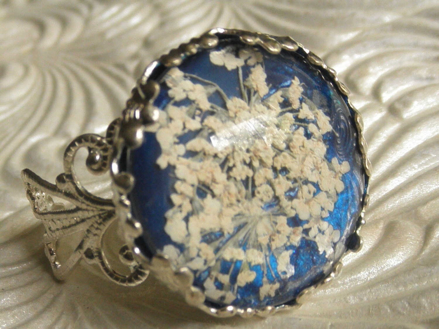 Victorian Filigree Pressed Flower Ring Glass with Queen Anne's Lace Atop True Blue Background, Symbolizes Peace