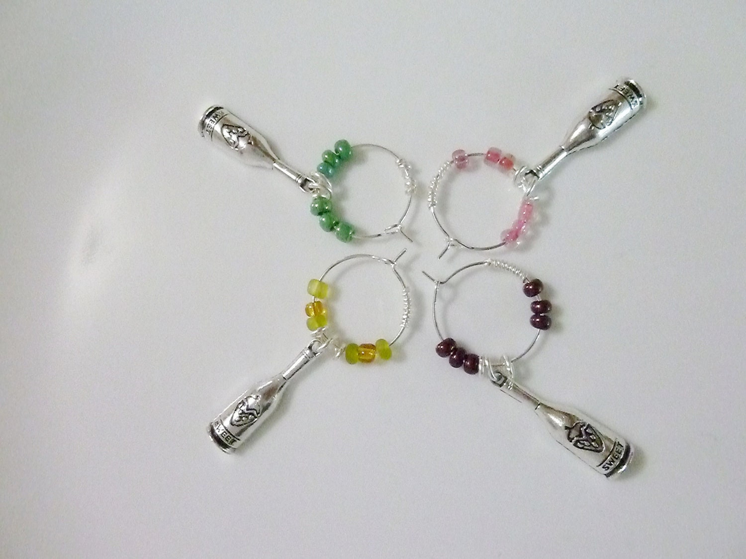 Set of 4 beaded Wine Bottle Charms in pink, maroon, yellow and green