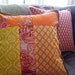 Orange Patchwork Indian Designer 16" x 16" Inch Throw Pillow with Green Pom Pom Fringe