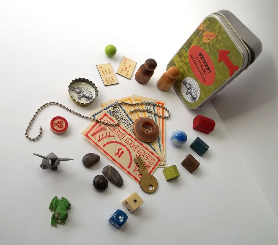 Small toys with tiny frog and penguin in a little tin box