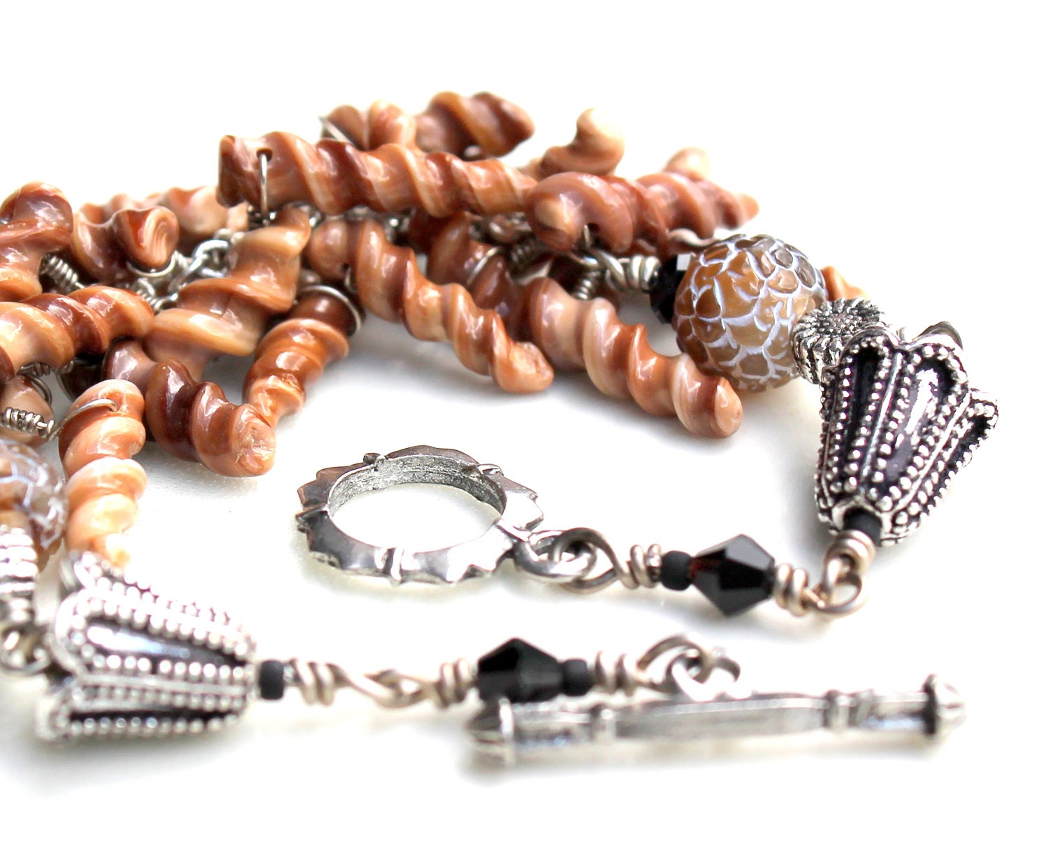 anchors away bracelet. spiral seashell wire wrapped bracelet. choco seashells. sunflowers. antiqued silver cones.