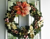 Pink and gold Poinsettia christmas wreath with pine cones, berries and christmas balls  .