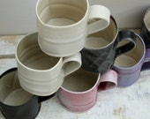 smooth textured coffee mugs in pink purple black and cream