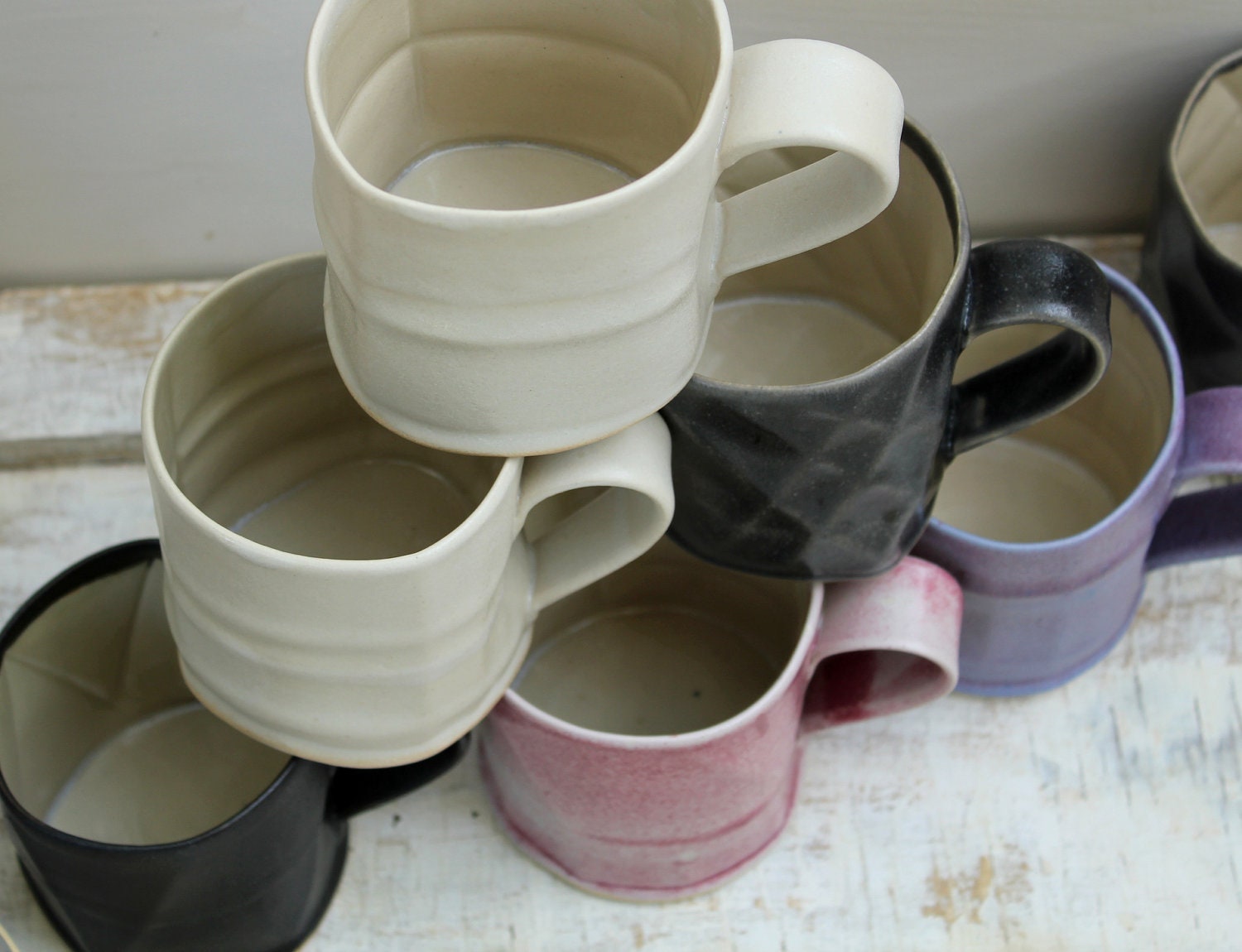 smooth textured coffee mugs in pink purple black and cream
