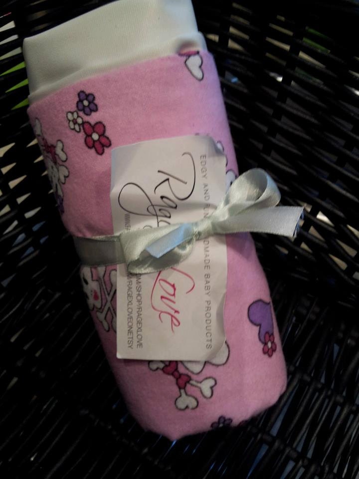 Pink skull and cross bone changing pad
