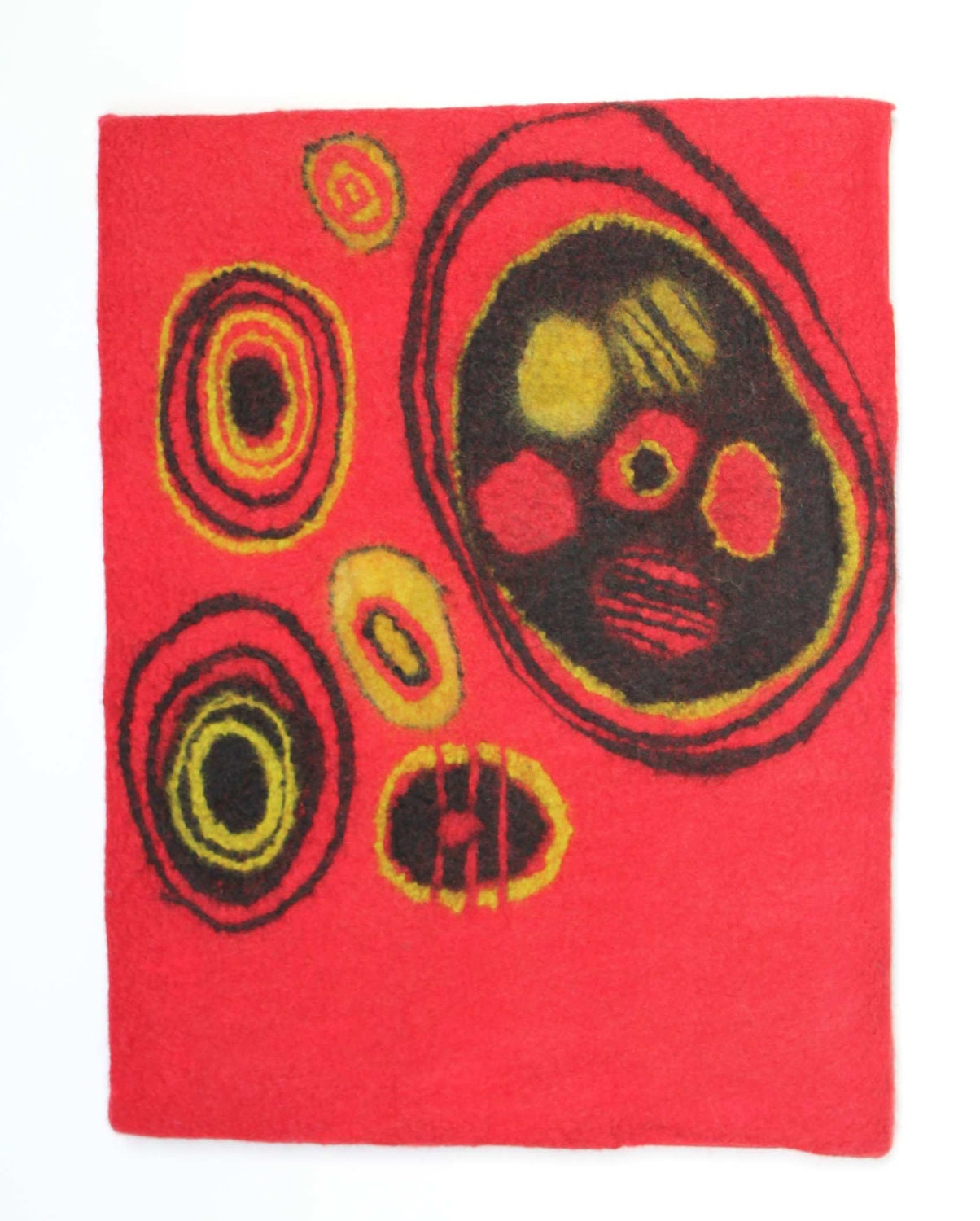 Red felt original wall art with circles.