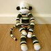 Striped sock monkey plush doll - brown, white, yellow, peach, and black, with vintage button