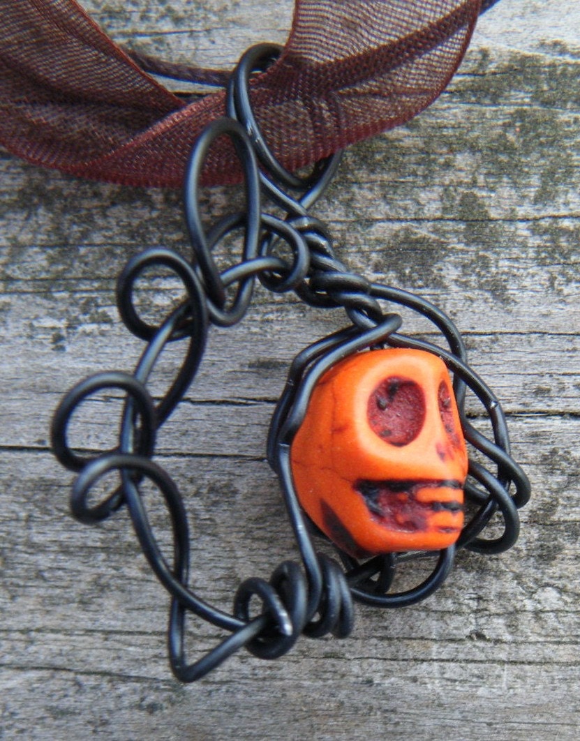 Day of the Dead Wire Wrapped Caged Carved Skull Magnesite Necklace. Orange Carved Skull Magnesite Pendant
